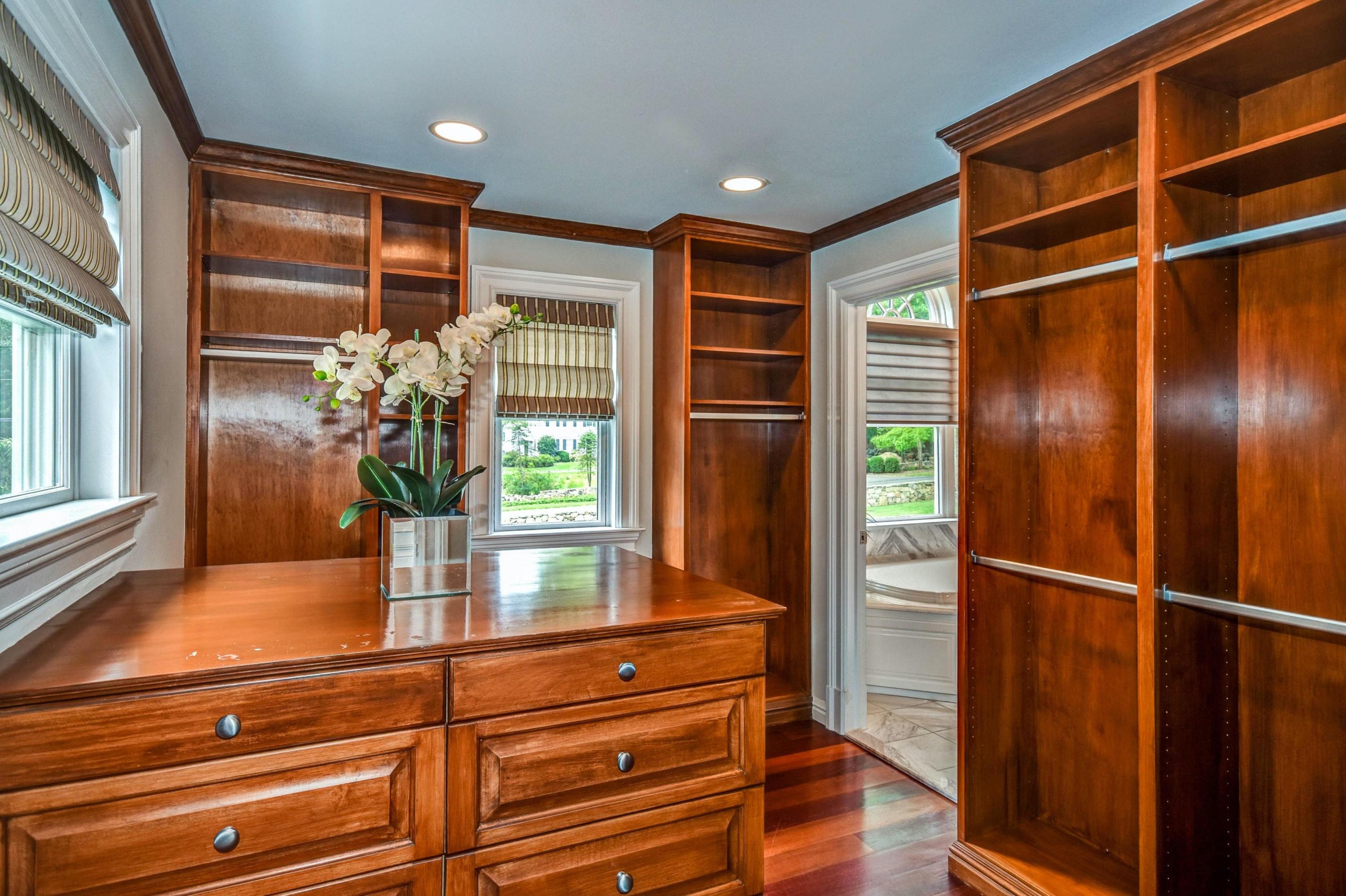 56 Logan Road New Canaan, CT 06840 - Photo 29 of 40 a view of walk in closet with wooden floor