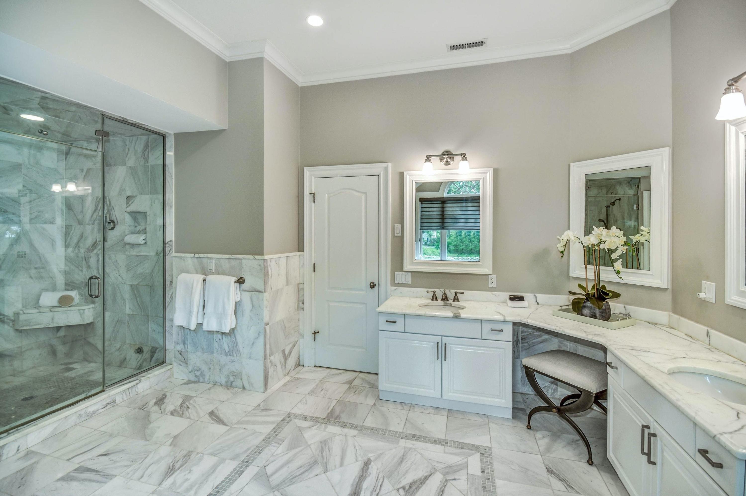 56 Logan Road New Canaan, CT 06840 - Photo 30 of 40 a bathroom with a sink double vanity granite tub shower and a mirror