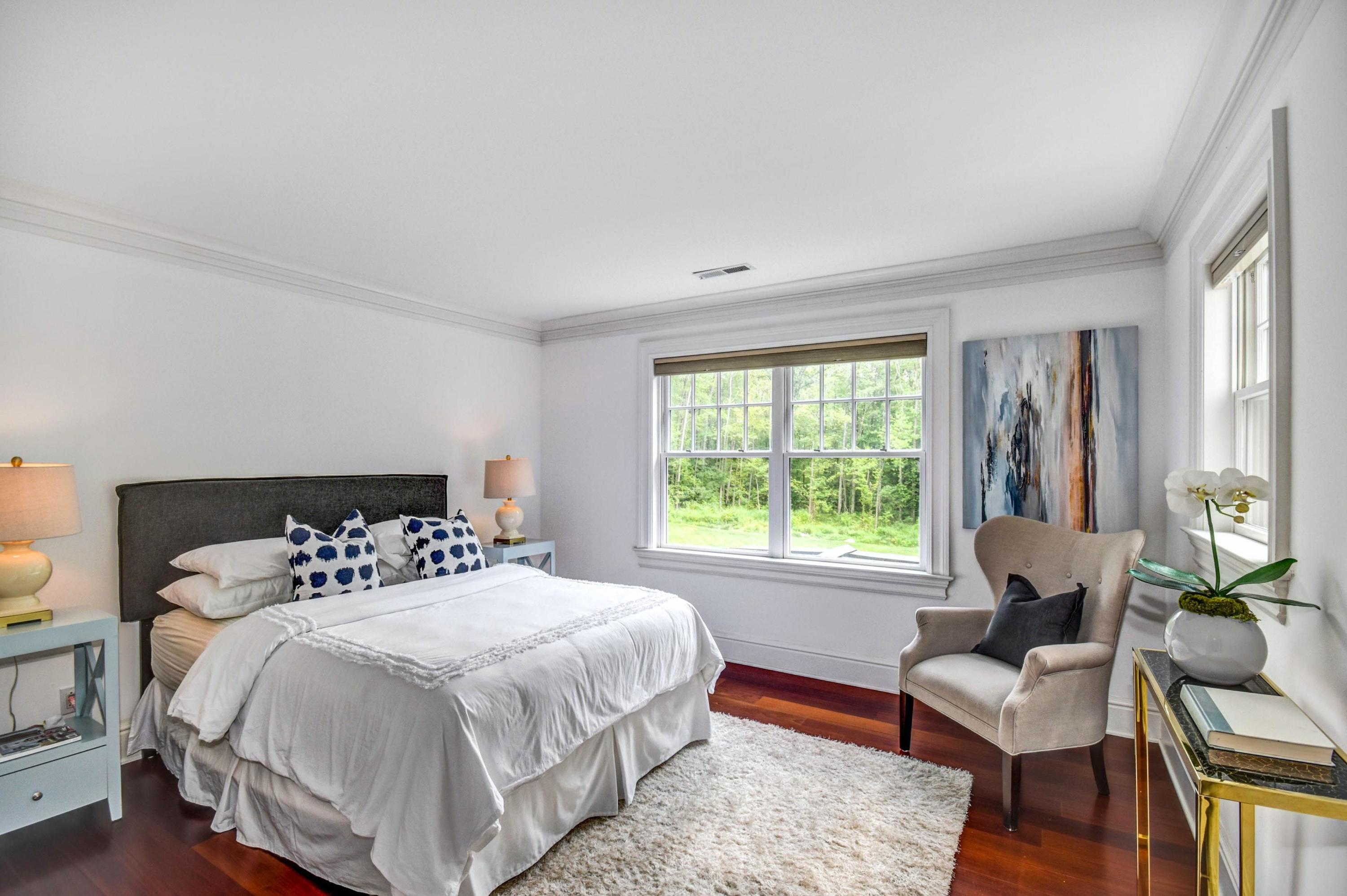 56 Logan Road New Canaan, CT 06840 - Photo 31 of 40 a bedroom with a bed and wooden floor