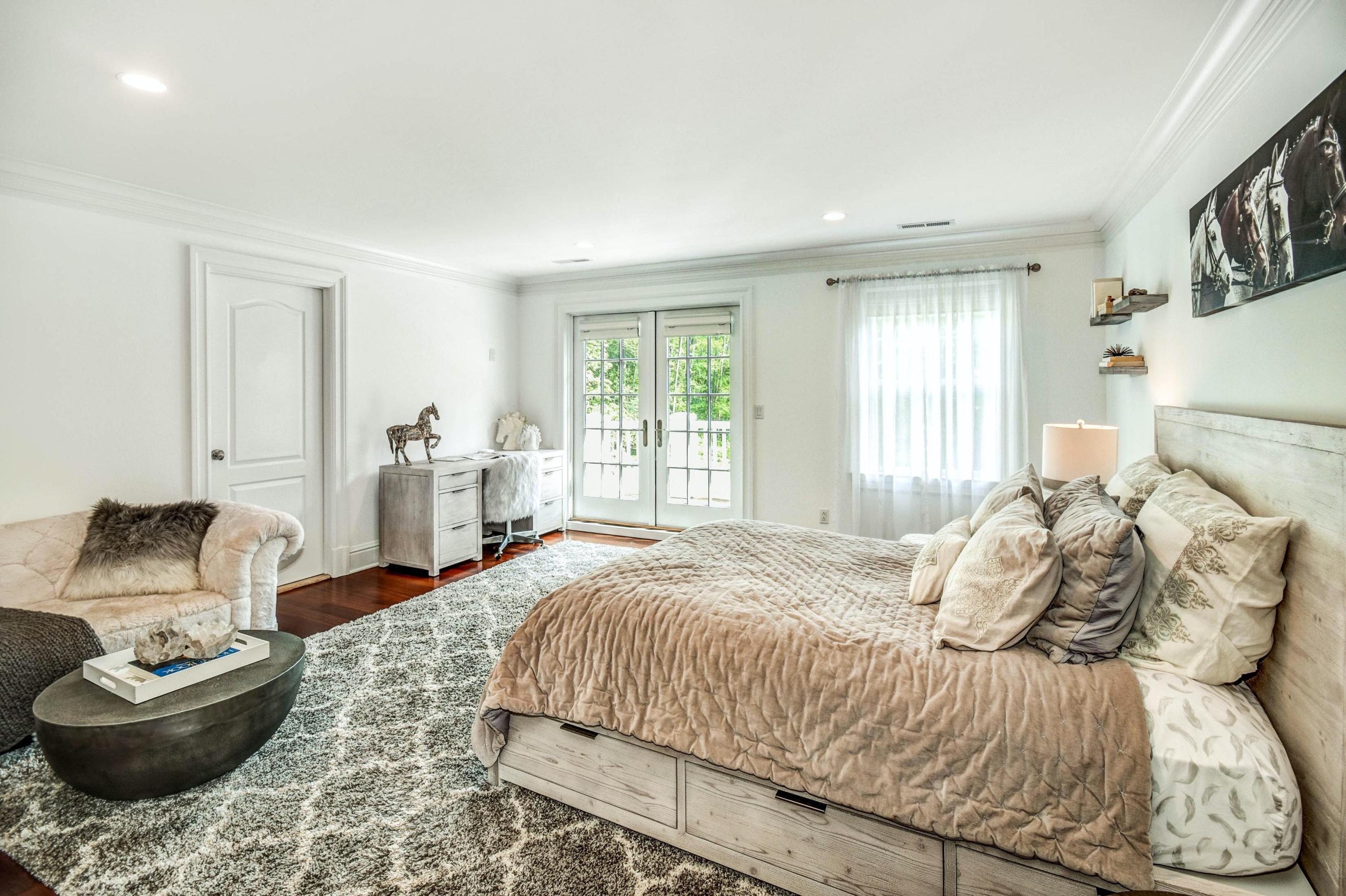 56 Logan Road New Canaan, CT 06840 - Photo 32 of 40 a bedroom with a large bed and a couch