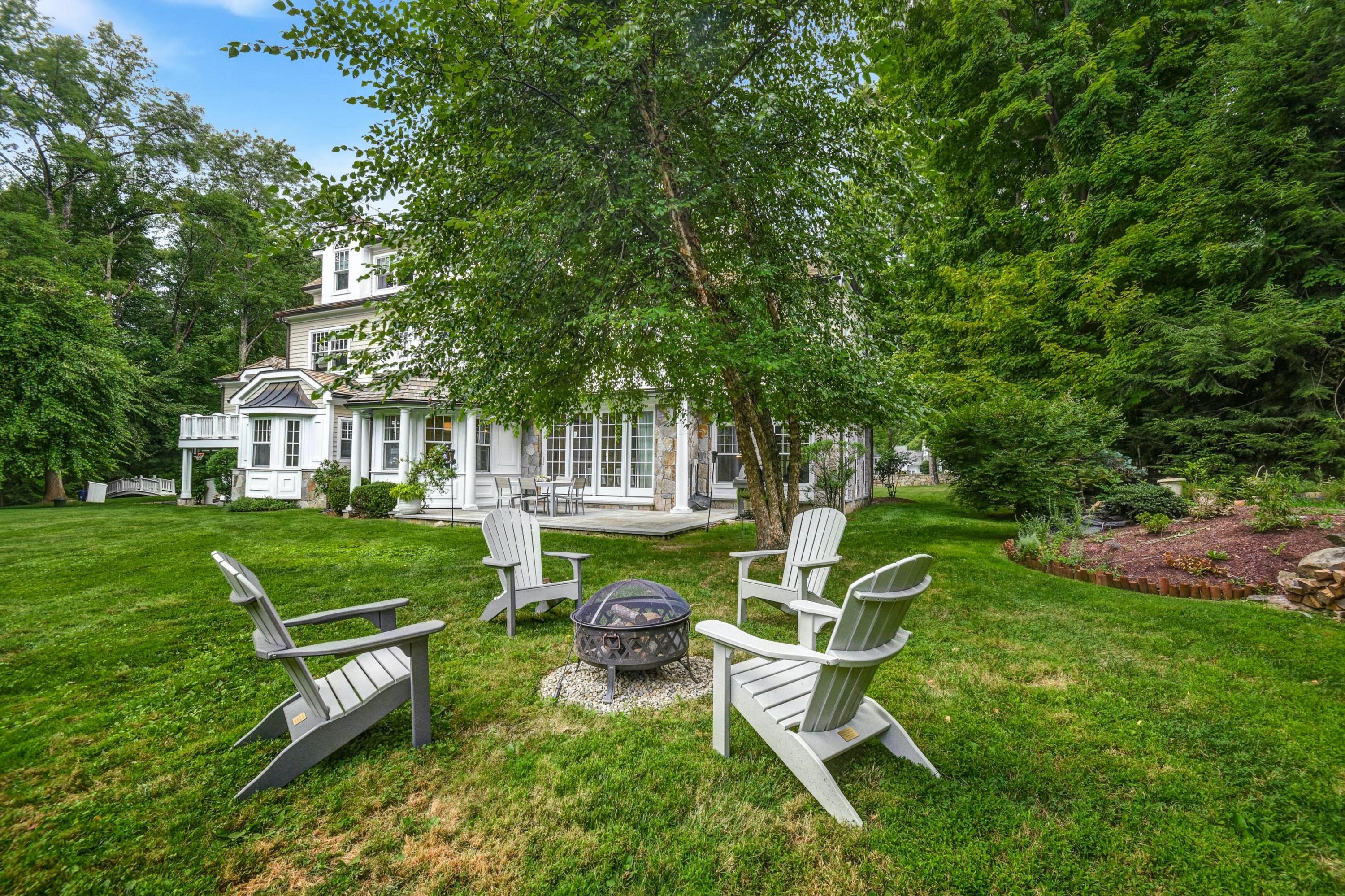 56 Logan Road New Canaan, CT 06840 - Photo 34 of 40 a view of a chair and table in the garden