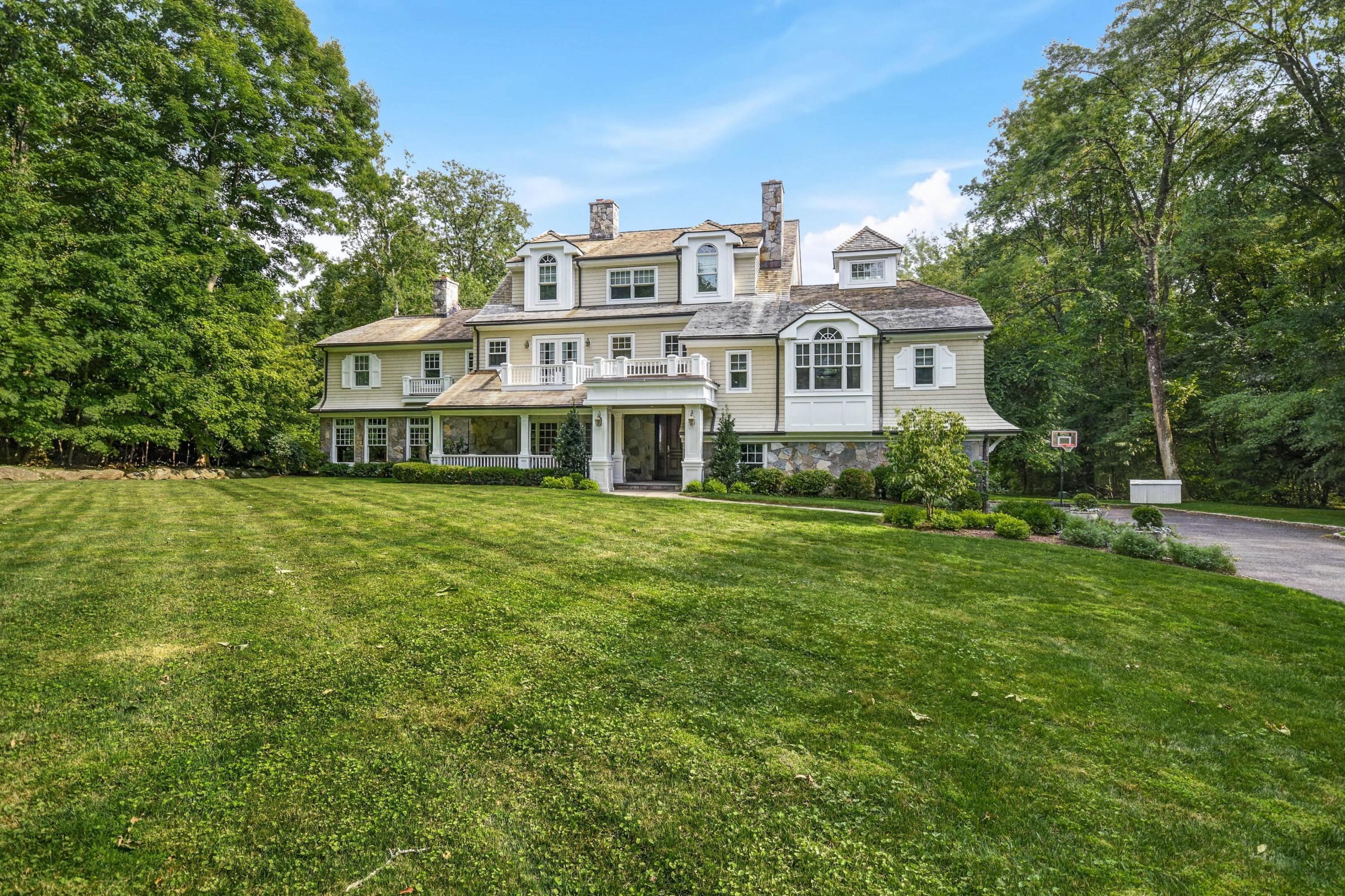 56 Logan Road New Canaan, CT 06840 - Photo 37 of 40 a view of a house with a big yard and large trees