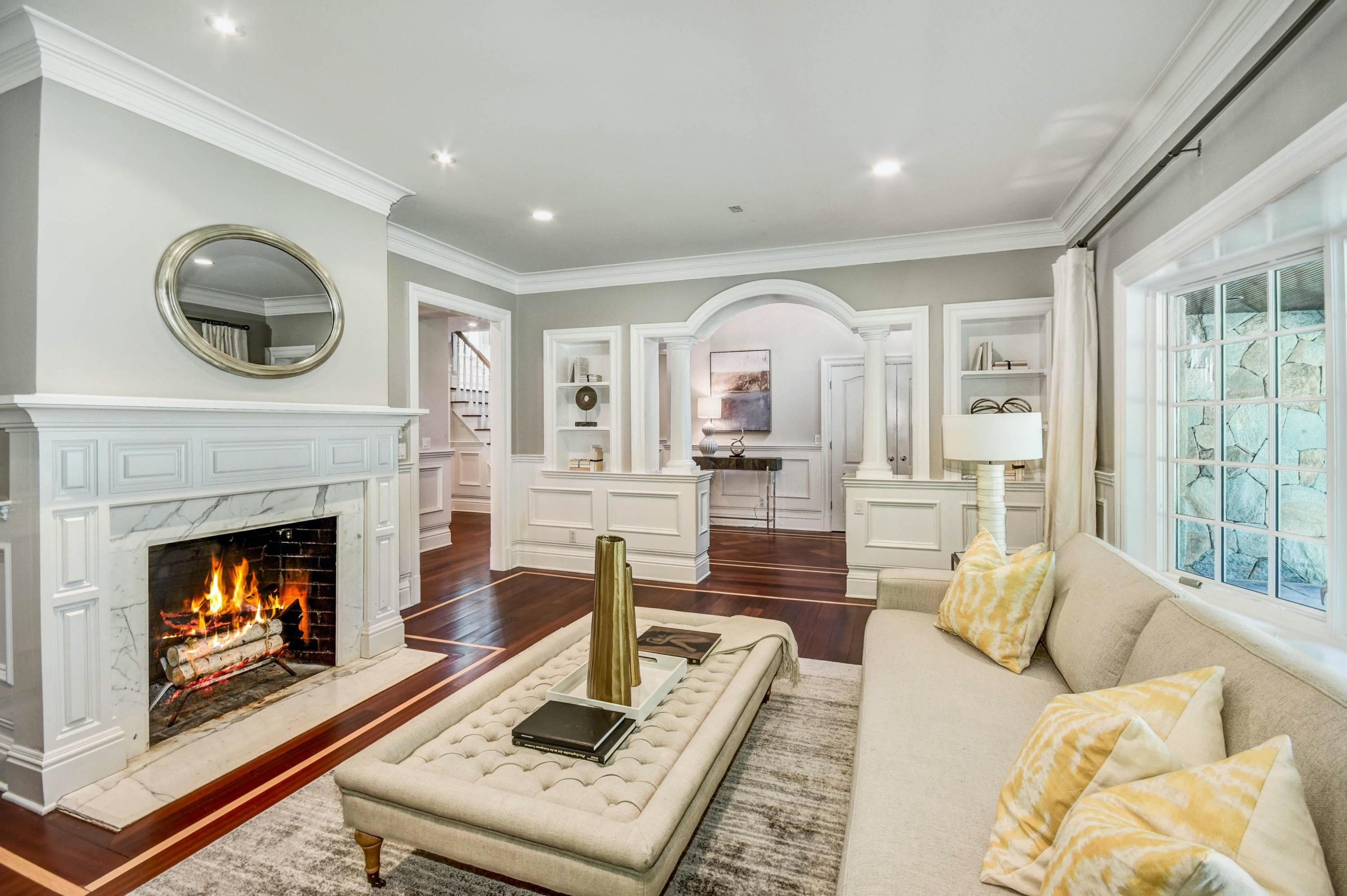56 Logan Road New Canaan, CT 06840 - Photo 7 of 40 a living room with furniture and a fireplace