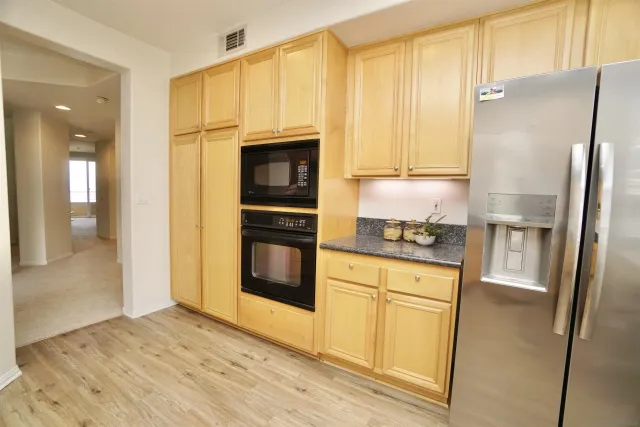 a kitchen with stainless steel appliances a refrigerator sink and cabinets