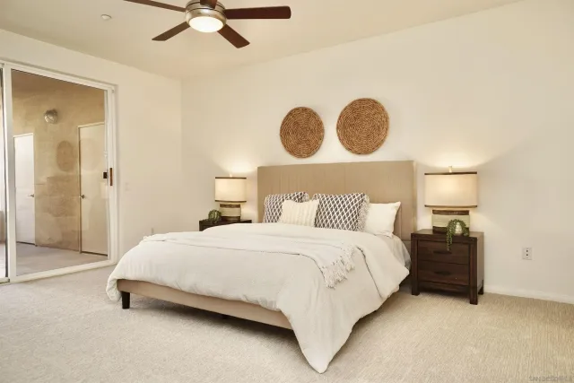 a bedroom with a bed and lamp