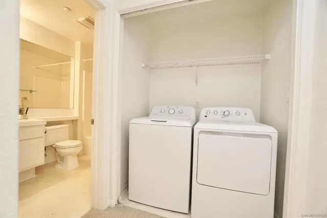 a view of a storage & utility room with dryer and washer