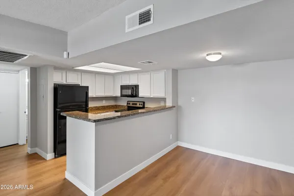 a kitchen with granite countertop a sink and a stove top oven