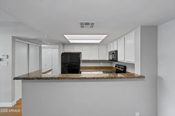 a kitchen that has a sink and a stove top oven