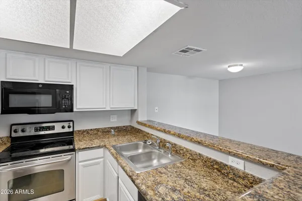 a kitchen with a refrigerator stove and microwave
