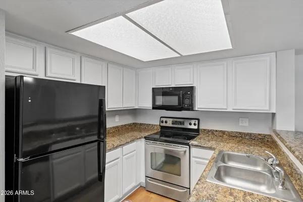 a white refrigerator freezer sitting in a kitchen