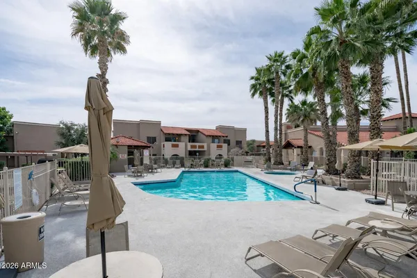 a view of a garden with a table and chairs