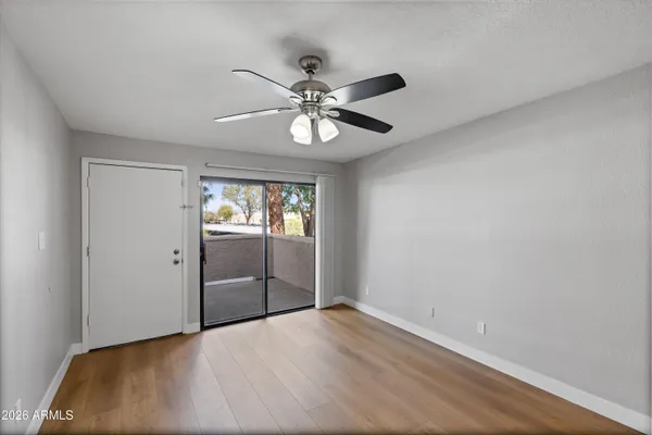 a view of kitchen with refrigerator microwave and wooden floor
