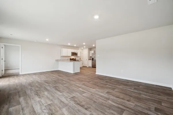 a view of kitchen with kitchen island wooden cabinets and center island
