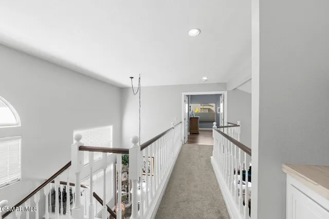 a view of a hallway with wooden floor and entryway