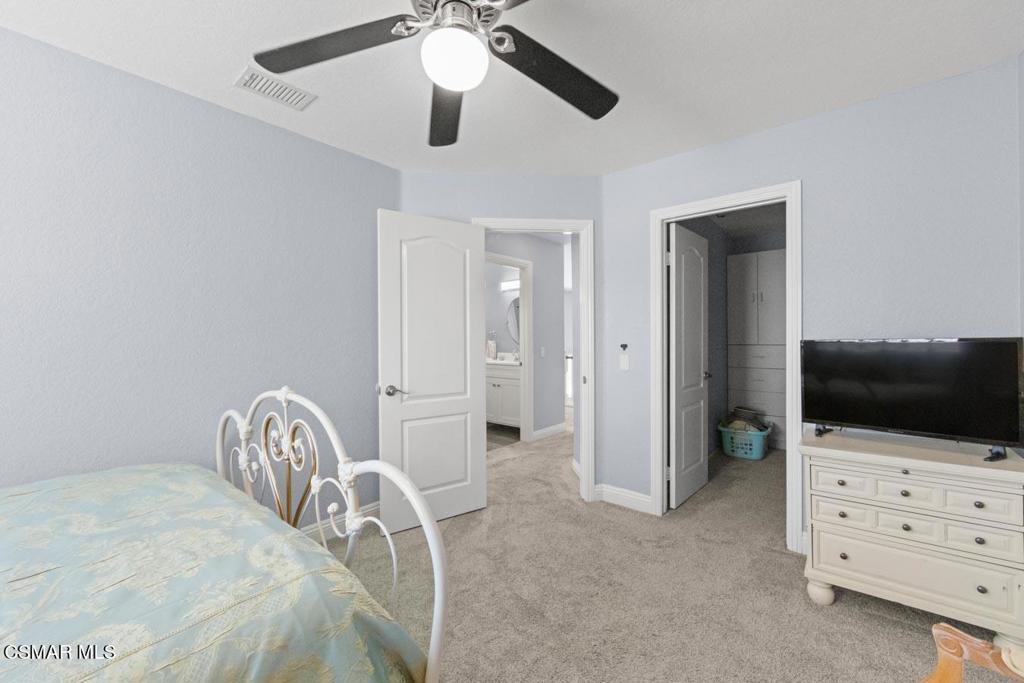 582 Fairfield Road Simi Valley, CA 93065 - Photo 19 of 31 a bedroom with a bed and a flat tv screen on dresser