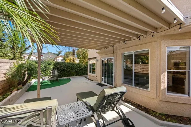 a view of a patio with table and chairs and potted plants