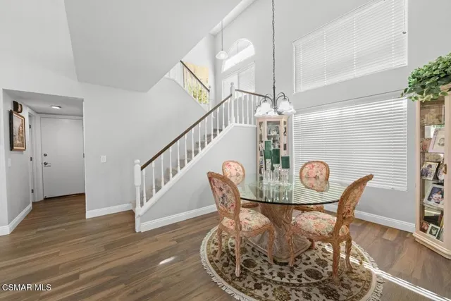a view of a dining room with furniture wooden floor and chandelier