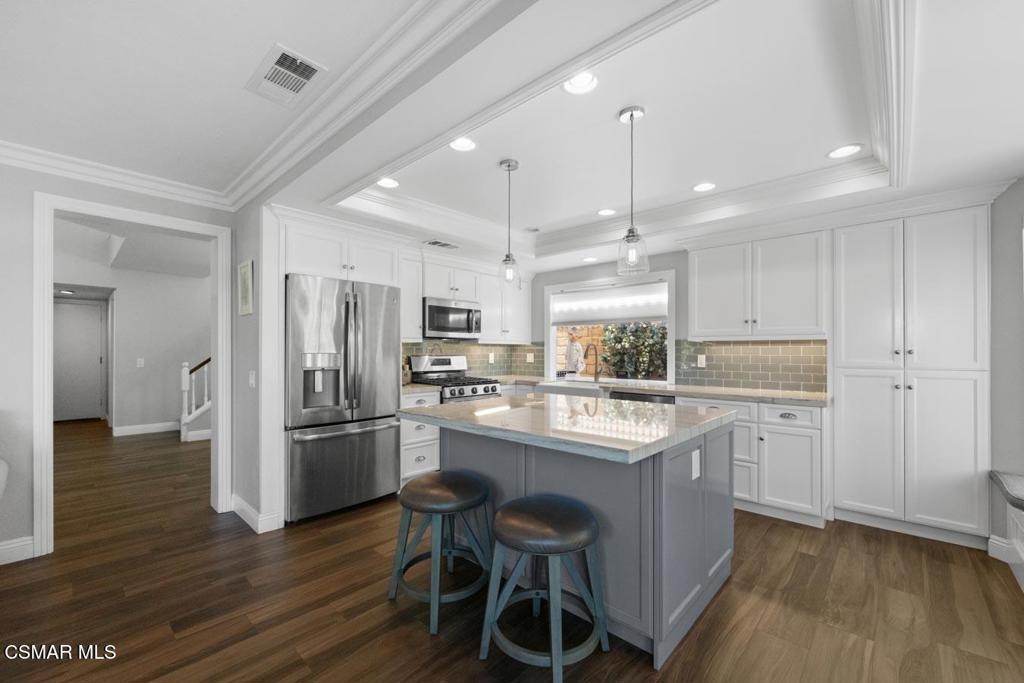 582 Fairfield Road Simi Valley, CA 93065 - Photo 10 of 31 a kitchen with refrigerator cabinets and wooden floor