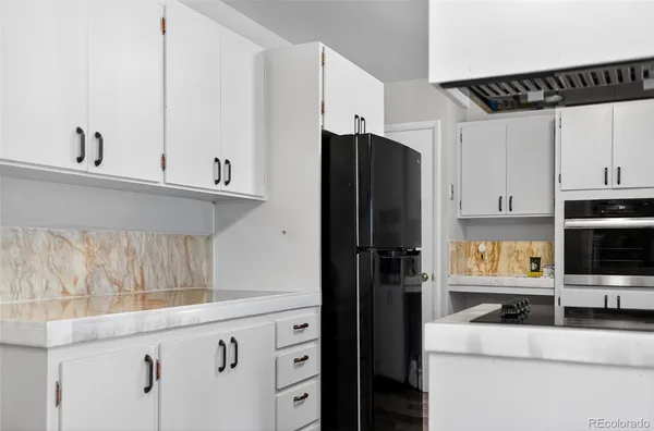 a kitchen with stainless steel appliances a refrigerator a stove and cabinets
