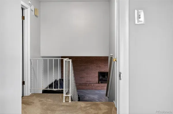 a view of an empty room with stairs and ventilation