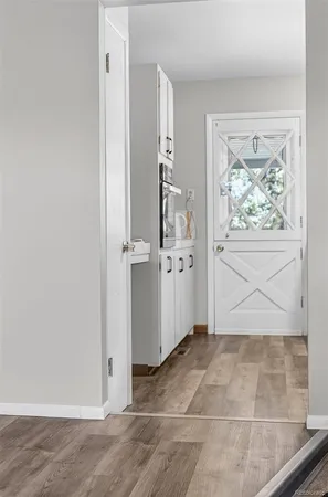 an empty room with wooden floor and a window