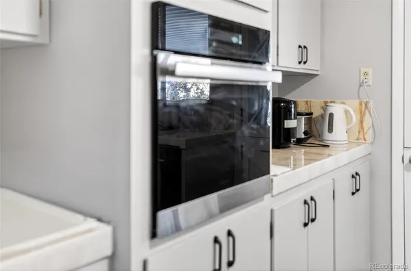 a close view of a kitchen sink and fireplace