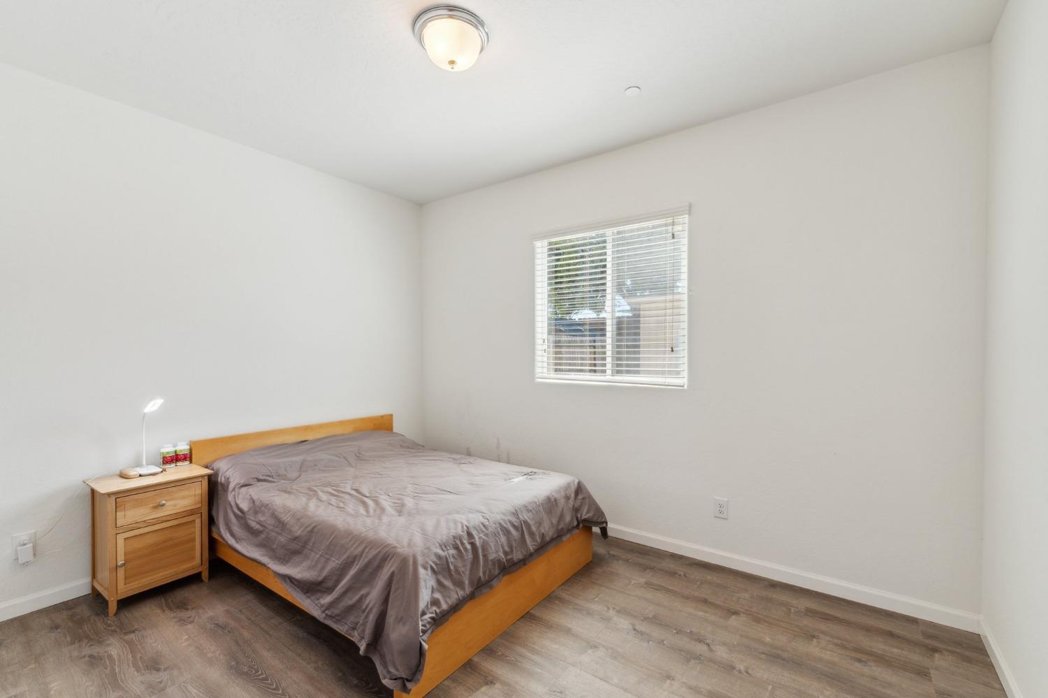 264 Rosebriar Street Madera, CA 93638 - Photo 12 of 28 a bedroom with a bed and chair
