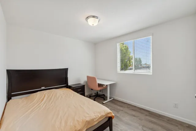 a bedroom with a bed and chair