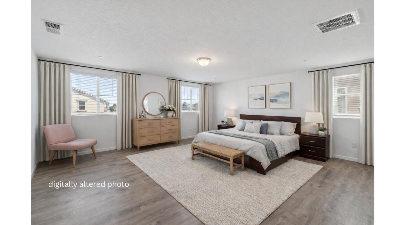 264 Rosebriar Street Madera, CA 93638 - Photo 16 of 28 a spacious bedroom with a bed couch and a window