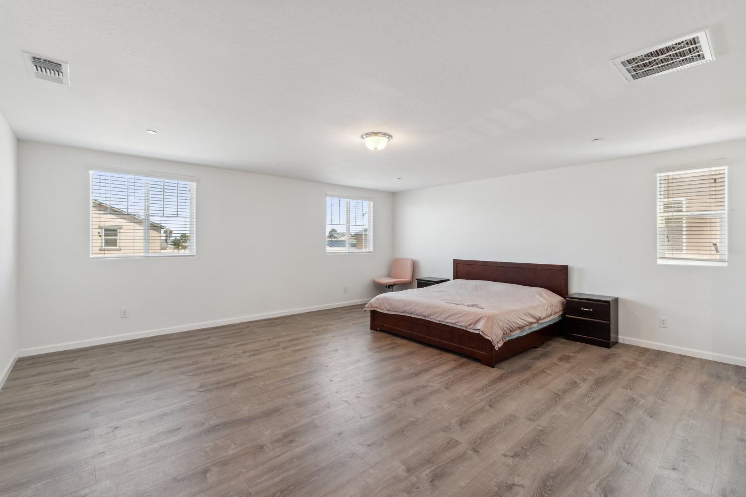 264 Rosebriar Street Madera, CA 93638 - Photo 17 of 28 a bedroom with a bed and a night stand