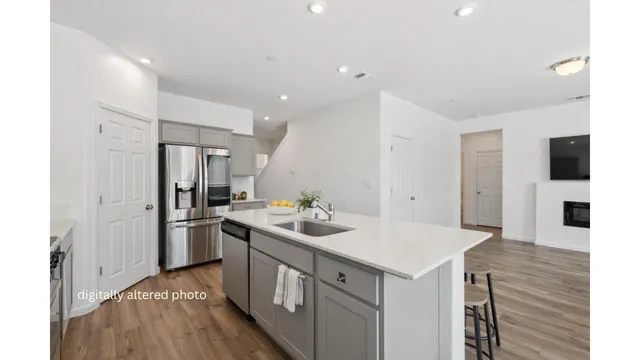 a kitchen that has a sink and a stove in it