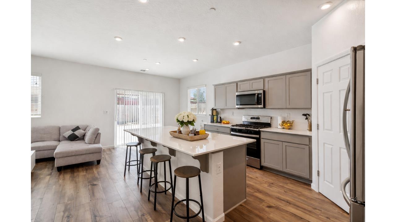 264 Rosebriar Street Madera, CA 93638 - Photo 6 of 28 a kitchen with a sink a stove a oven a dining table and chairs
