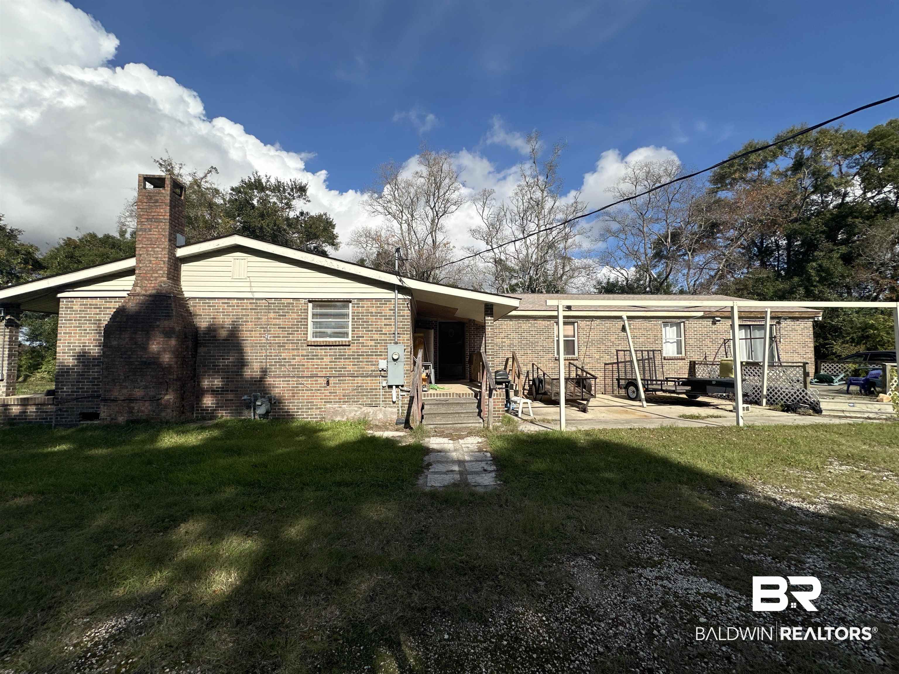 9520 C Four Mile Road Irvington, AL 36544 - Photo 30 of 32 Back of property with a yard and a patio