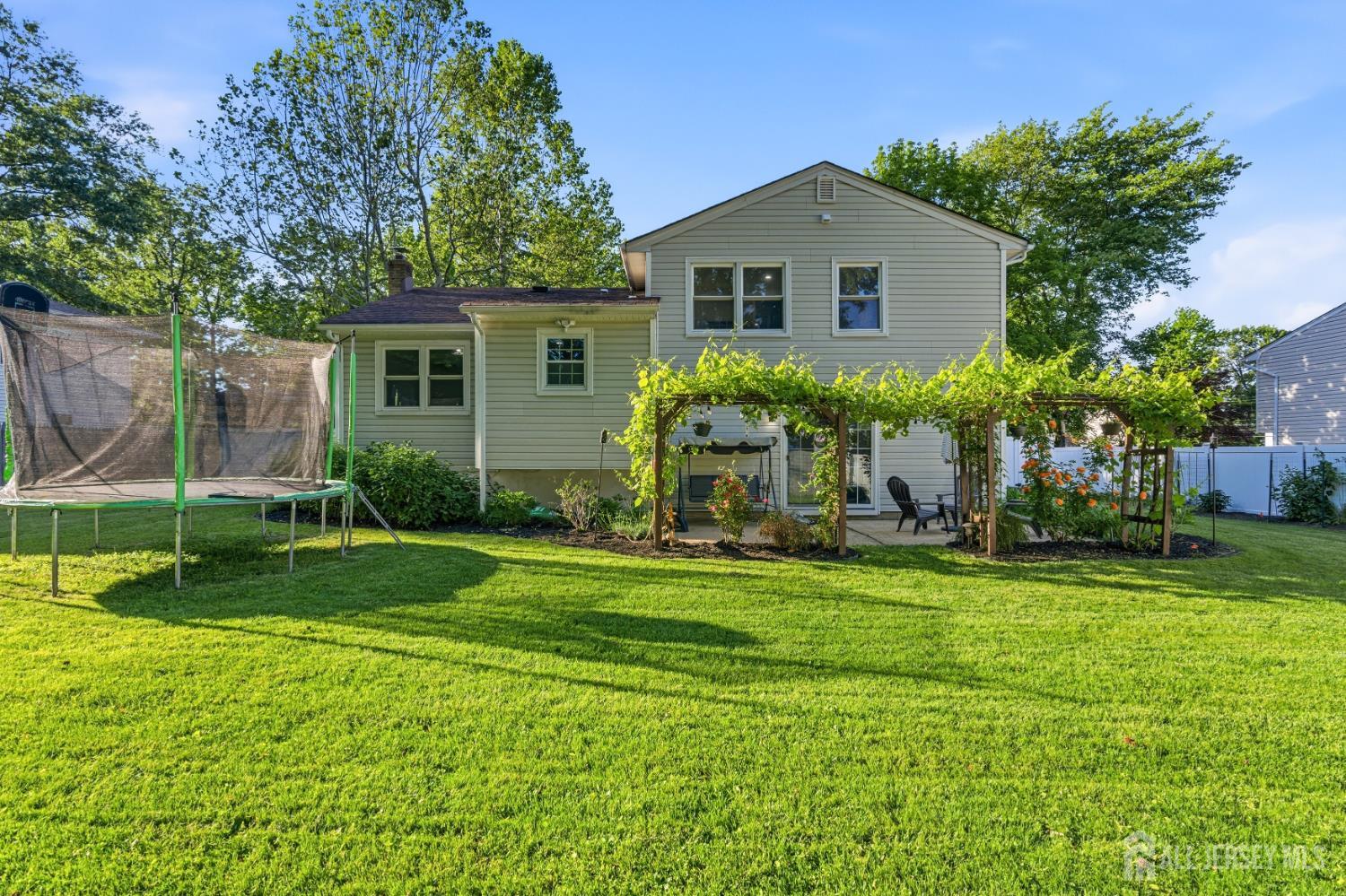 5 McKinley Street Edison, NJ 08820 - Photo 32 of 38 a front view of house with yard and green space