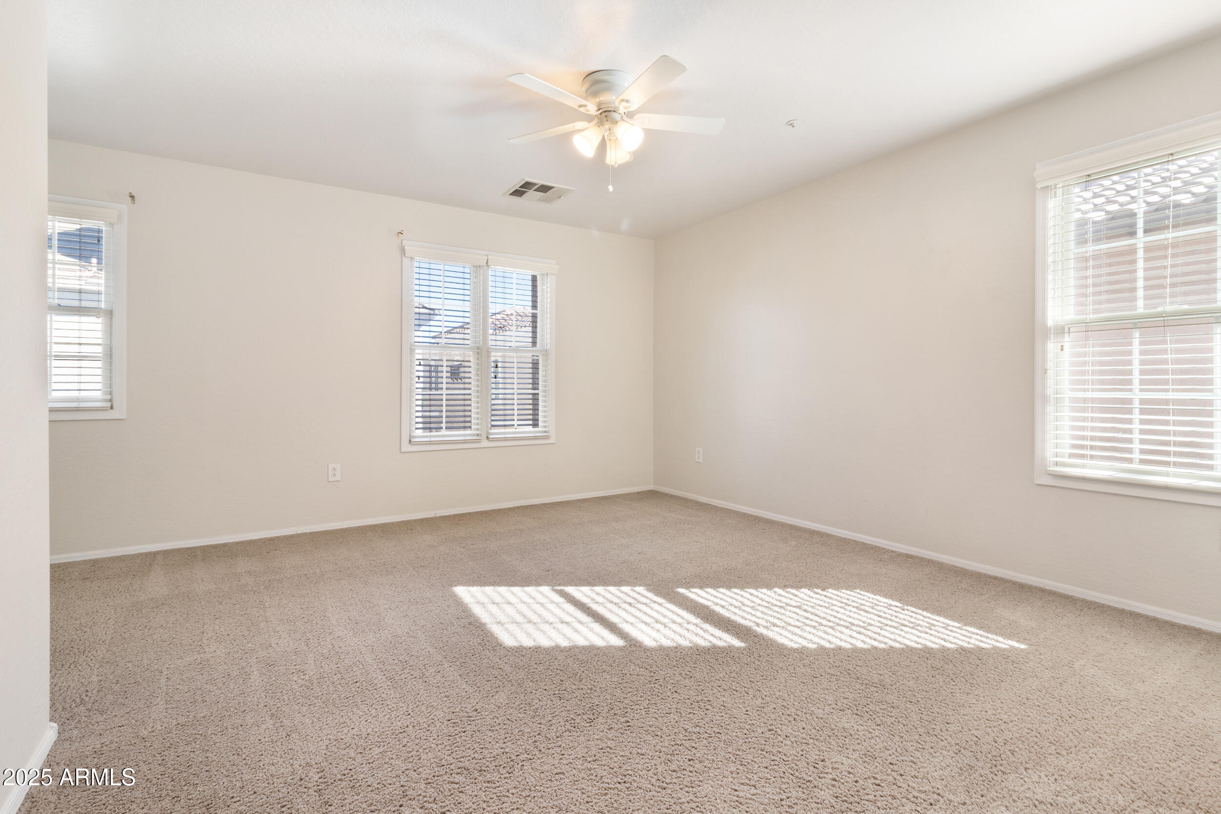 2789 South Key Biscayne Drive Gilbert, AZ 85295 - Photo 18 of 47 an empty room with windows and fan
