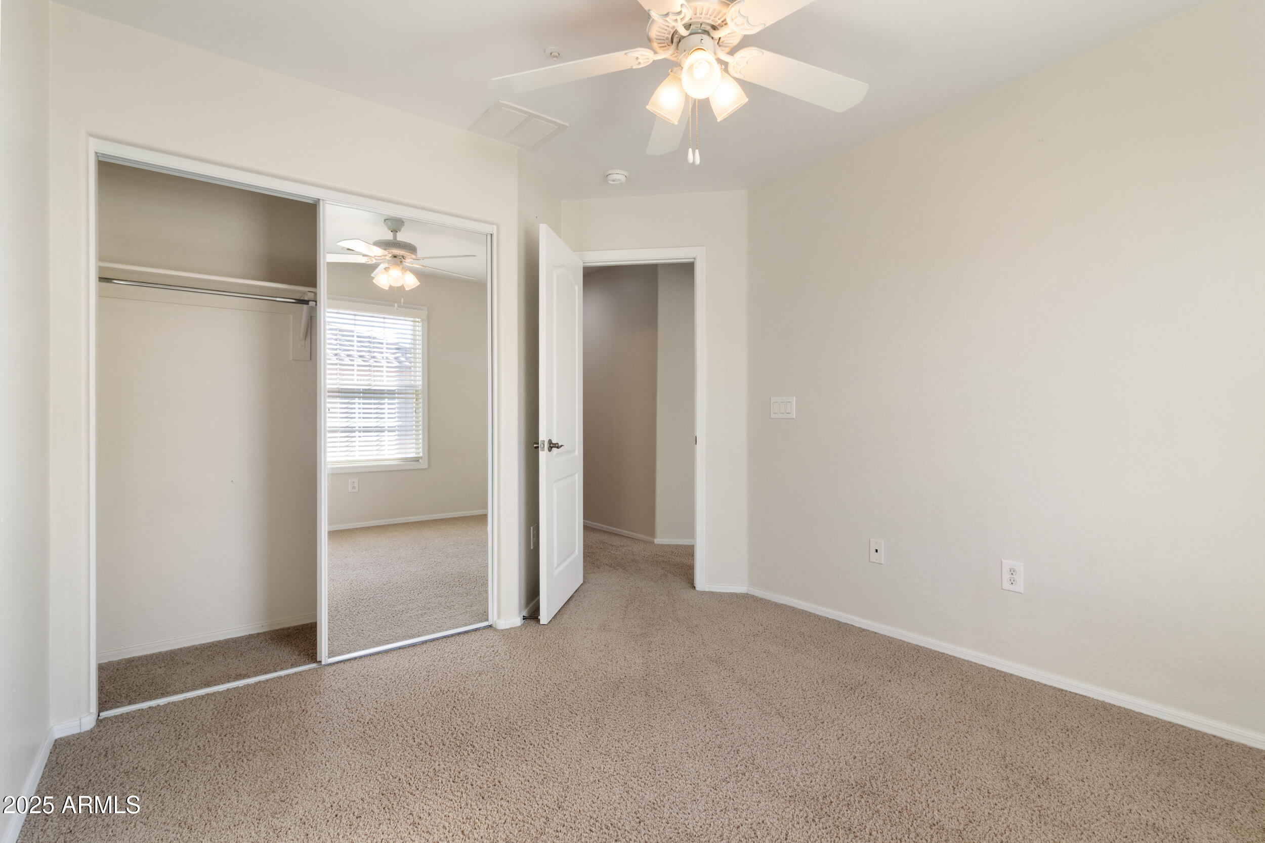 2789 South Key Biscayne Drive Gilbert, AZ 85295 - Photo 29 of 47 an empty room with closet and a chandelier fan
