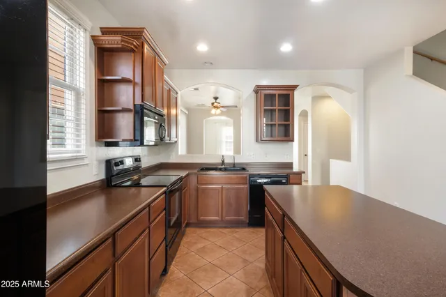 a kitchen with a sink stove and cabinets