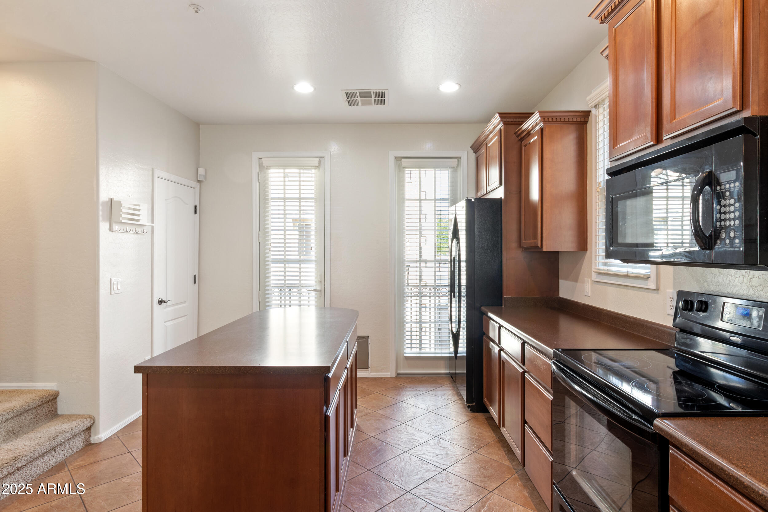 2789 South Key Biscayne Drive Gilbert, AZ 85295 - Photo 9 of 47 a kitchen with stainless steel appliances granite countertop a refrigerator and a stove top oven