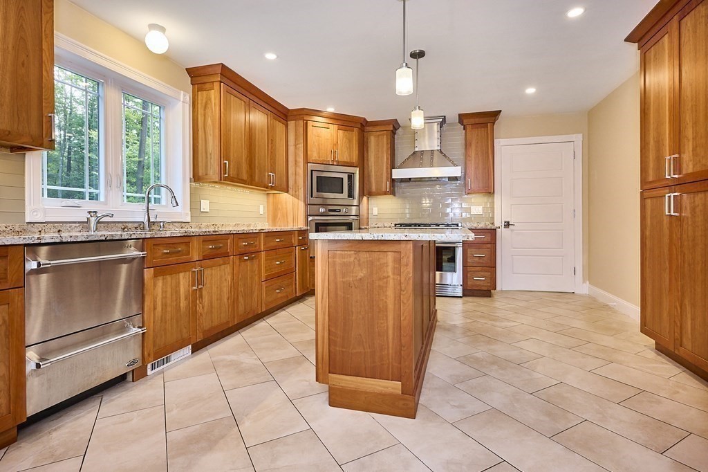 107 Concord Way Amherst, MA 01002 - Photo 16 of 41 a large kitchen with cabinets and stainless steel appliances