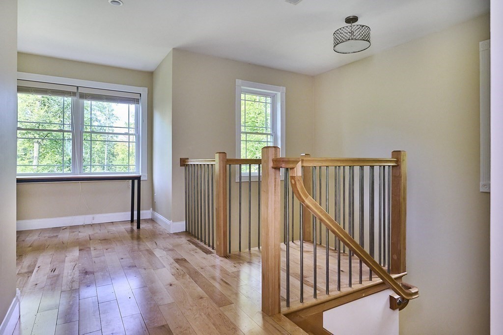 107 Concord Way Amherst, MA 01002 - Photo 18 of 41 a view of hallway with wooden floor and a window