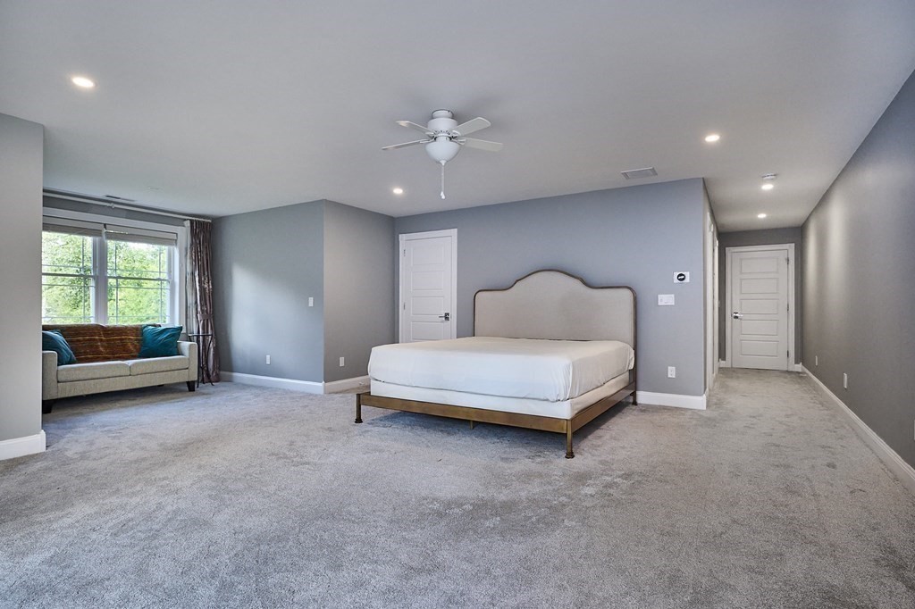 107 Concord Way Amherst, MA 01002 - Photo 19 of 41 a spacious bedroom with a bed a couch and a window