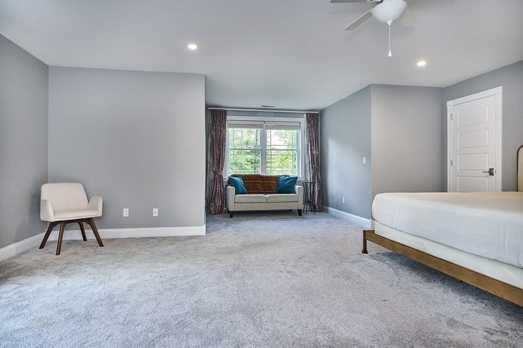 107 Concord Way Amherst, MA 01002 - Photo 21 of 41 a bedroom with a bed and a chair