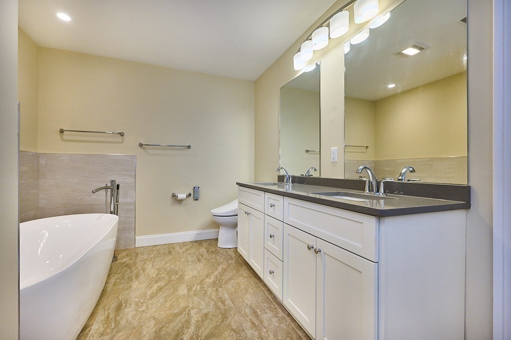 107 Concord Way Amherst, MA 01002 - Photo 27 of 41 a bathroom with a granite countertop sink a toilet and a bathtub
