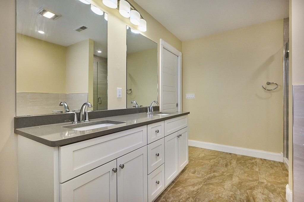 107 Concord Way Amherst, MA 01002 - Photo 29 of 41 a bathroom with a granite countertop sink and a mirror