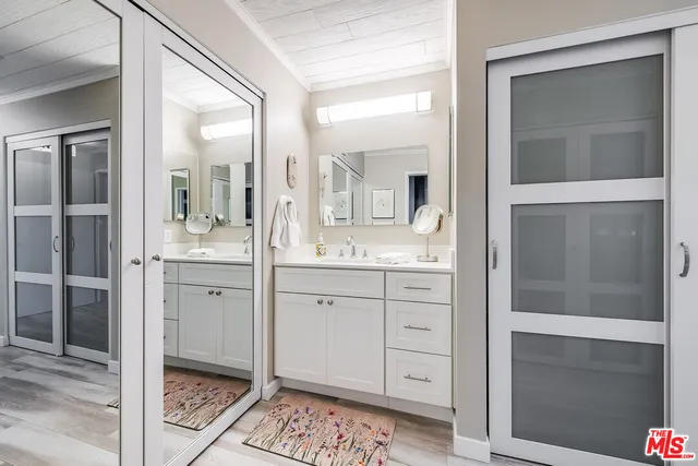 a spacious bathroom with a mirror sink and vanity