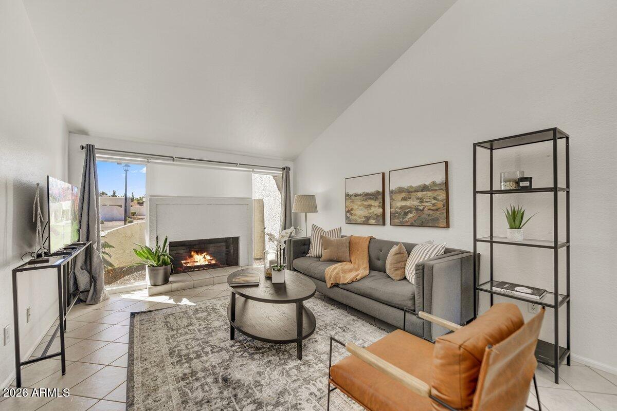 1301 West Rio Salado Parkway, Unit 51 Mesa, AZ 85201 - Photo 1 of 30 a living room with furniture a fireplace and a large window