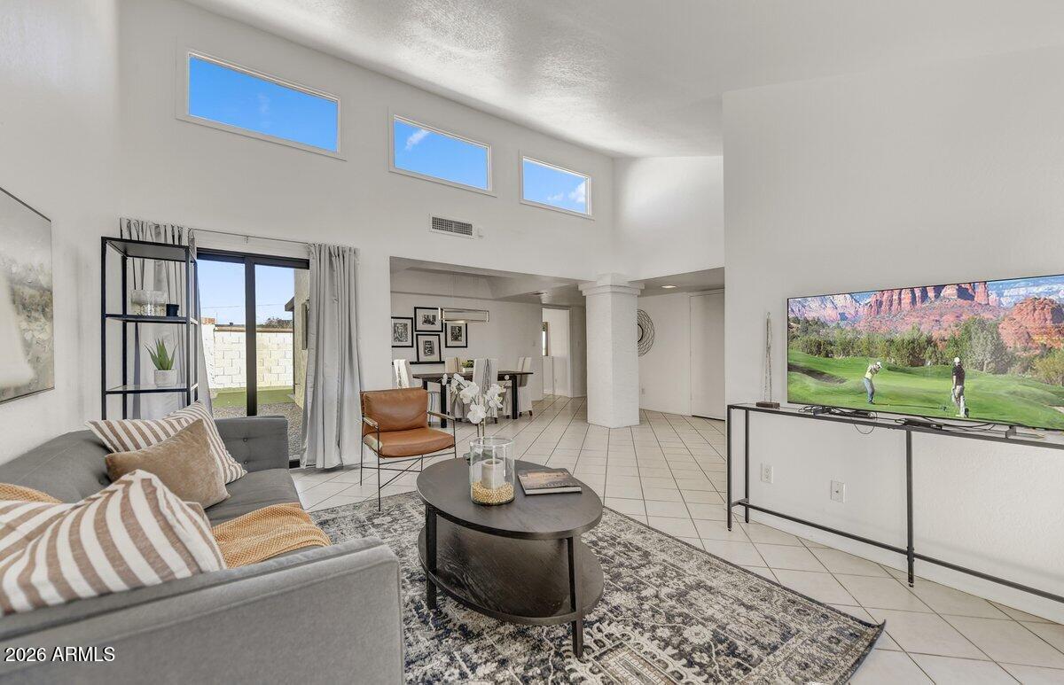 1301 West Rio Salado Parkway, Unit 51 Mesa, AZ 85201 - Photo 4 of 30 a living room with furniture and a floor to ceiling window