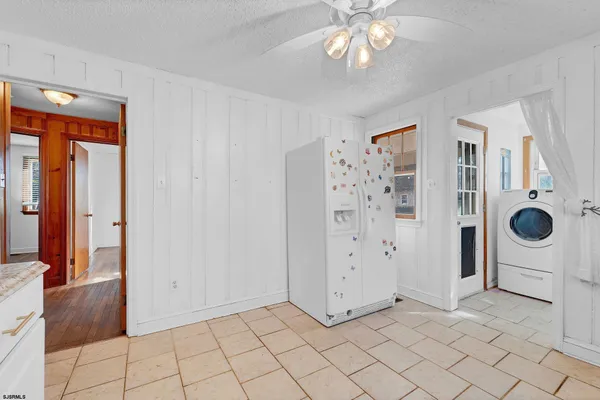 a kitchen with white cabinets appliances and a sink