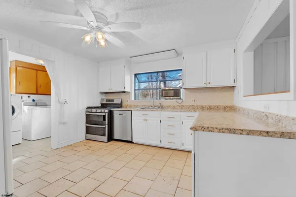 a kitchen with a cabinets and white appliances