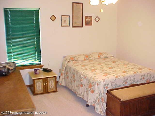 8407 Lamount Drive Amarillo, TX 79110 - Photo 11 of 12 a bedroom with a bed and a window